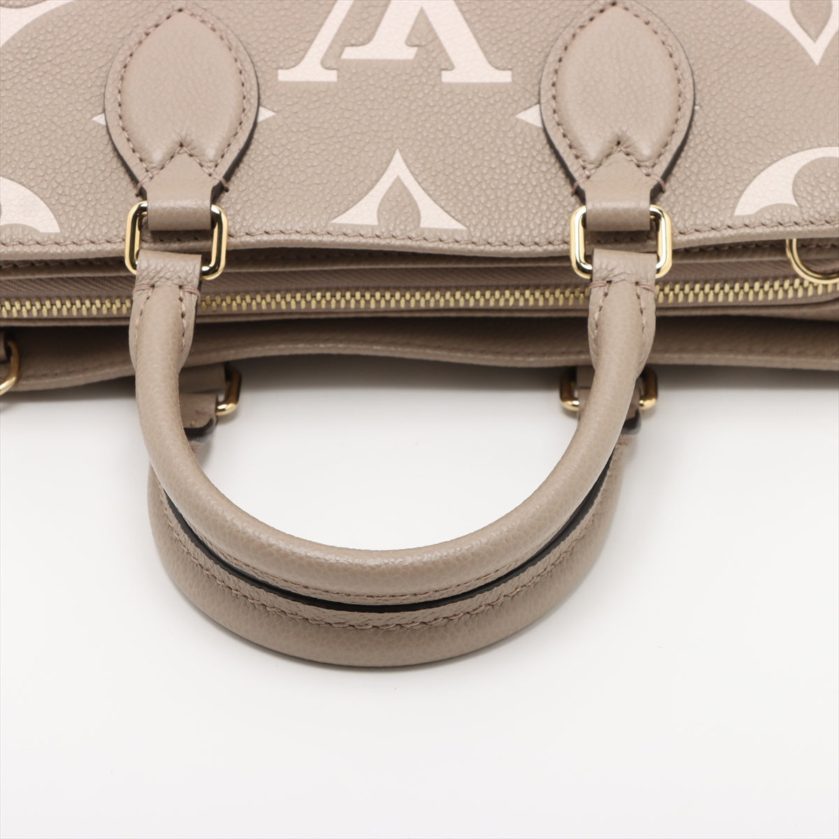 Onthego Leder East West Empreinte Tote Handtasche Taupe 
