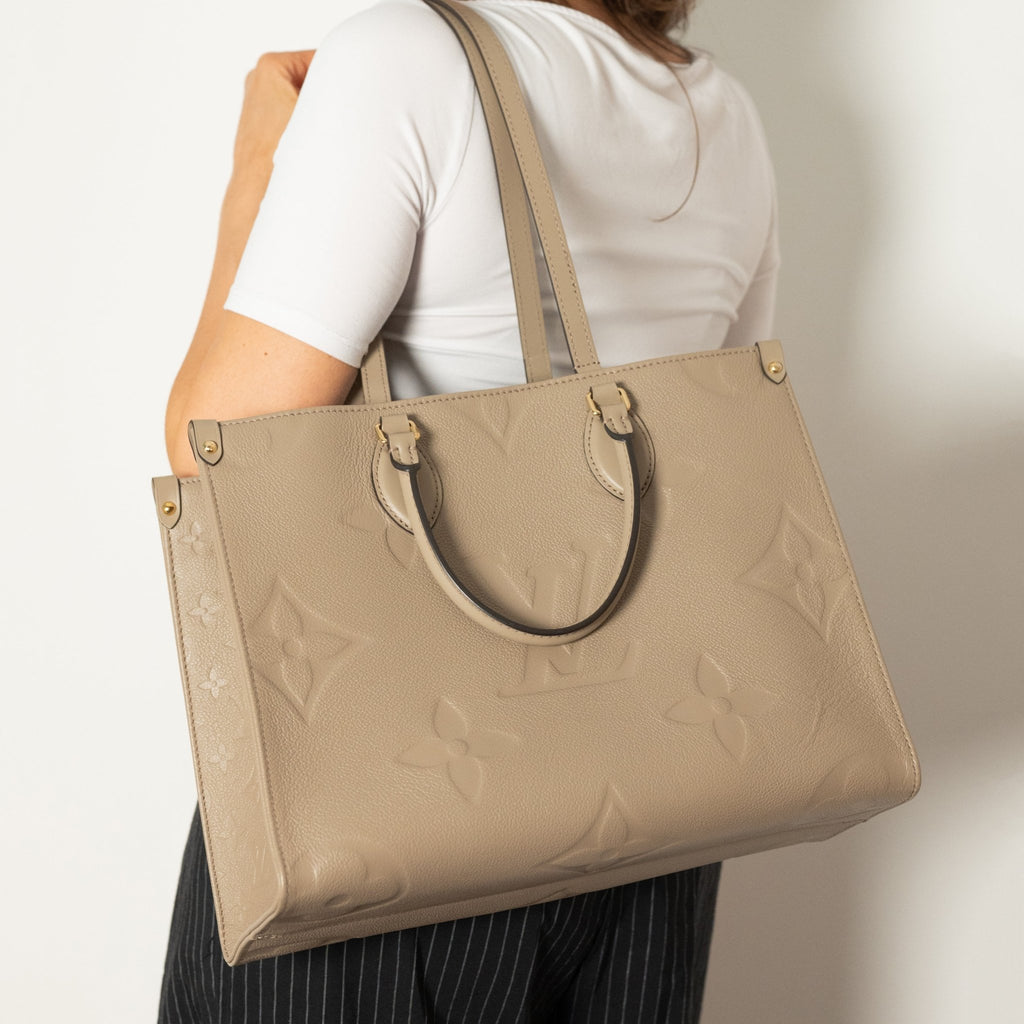 Second hand Louis Vuitton Onthego MM Empreinte Calfskin Grained Leather Tote Shoulder Bag Beige - Tabita Bags