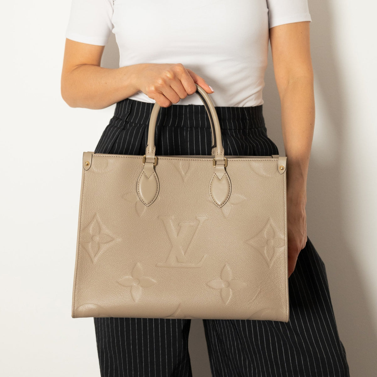 Second hand Louis Vuitton Onthego MM Empreinte Calfskin Grained Leather Tote Shoulder Bag Beige - Tabita Bags