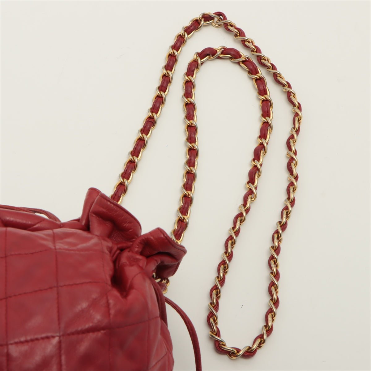 Second hand Chanel Mini Drawstring Bucket 1986-1988 Red Quilted Lambskin Gold - Tabita Bags